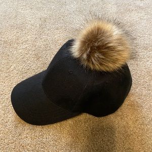Black cap with caramel pom